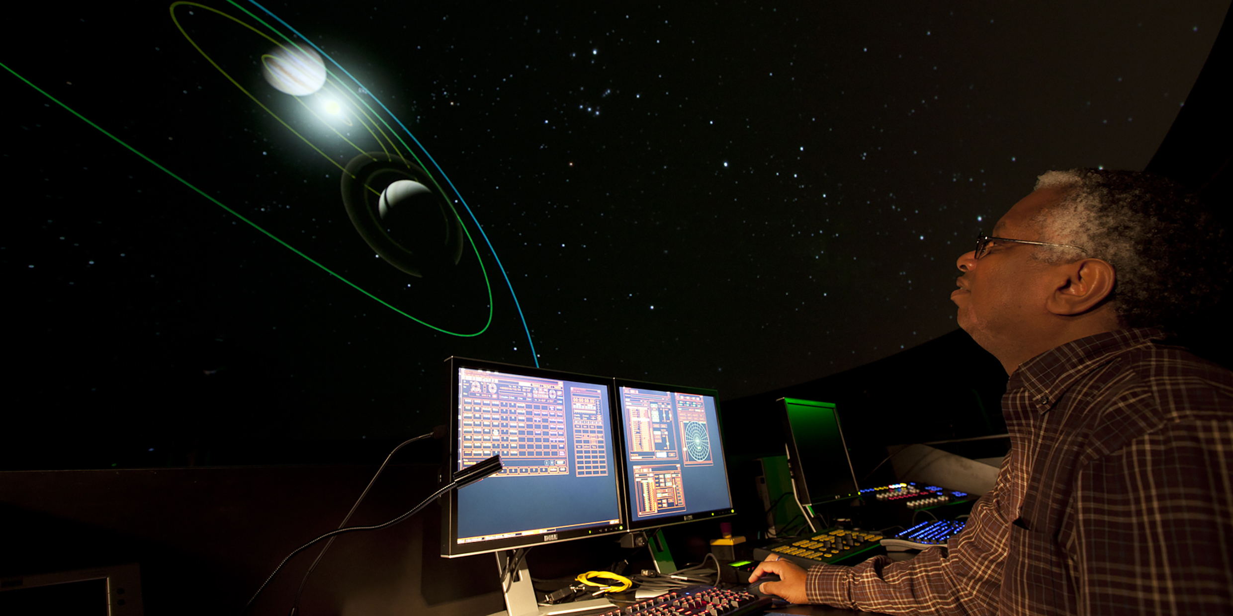 Image of man directing computer-controlled planetarium show