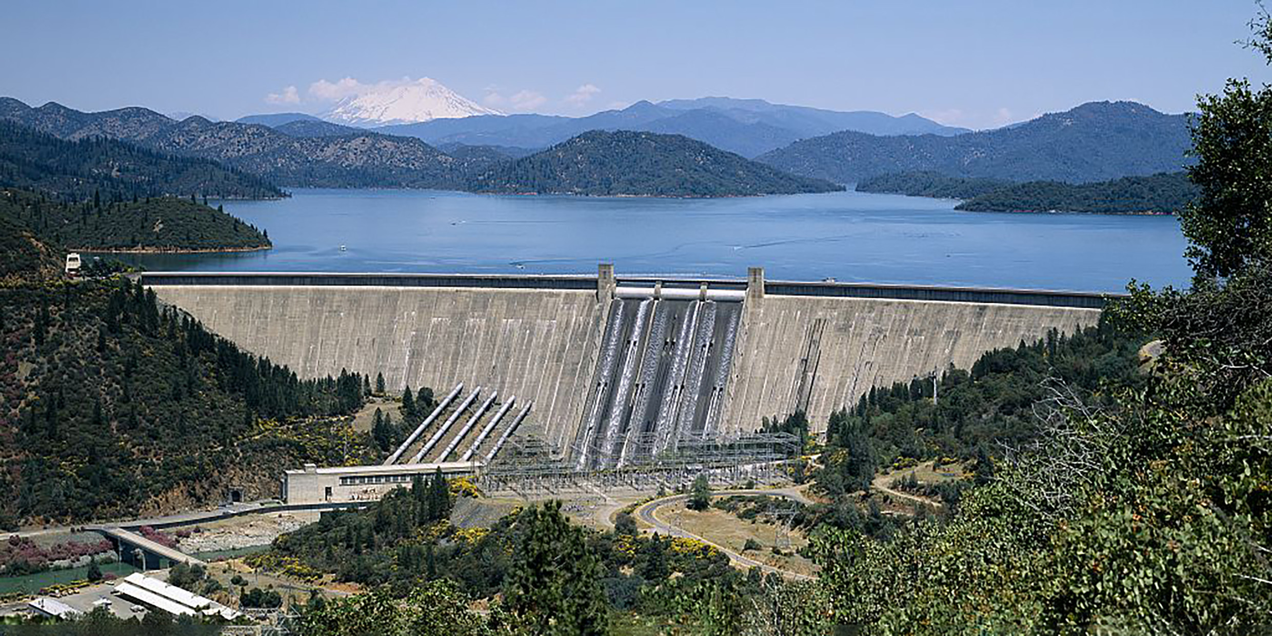 Image of concrete dam among rolling green hills