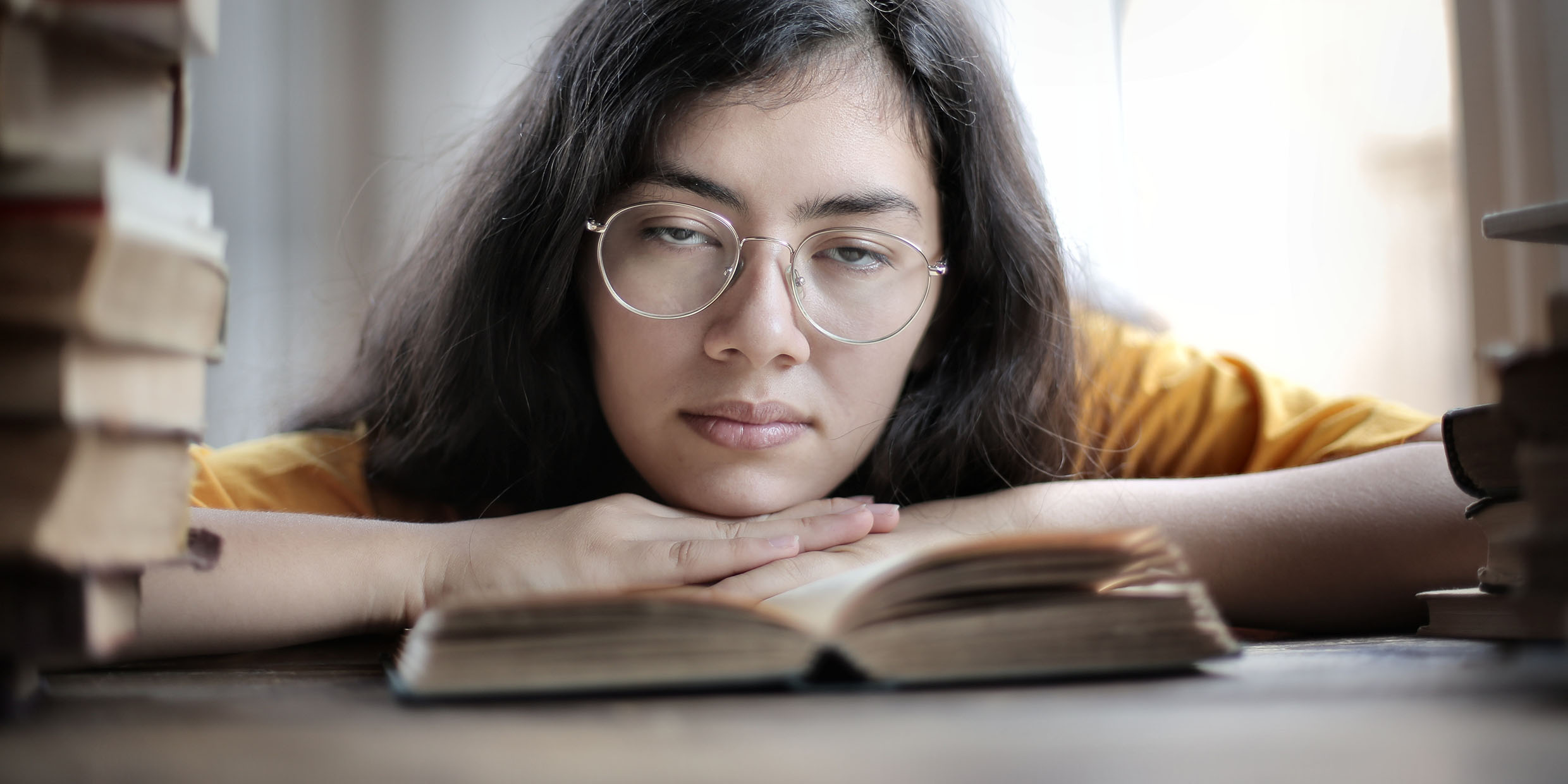 Image of bored woman reading books