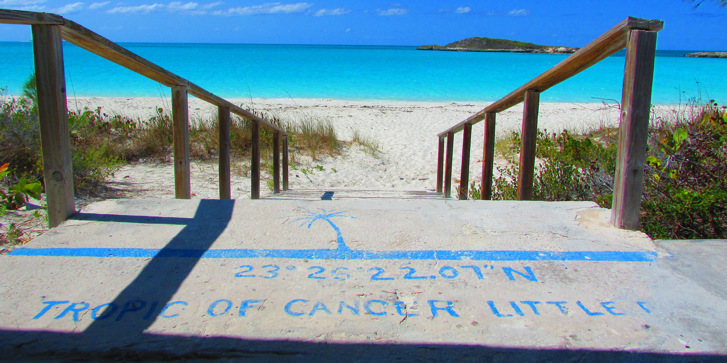 Image of line marking the Tropic of Cancer painted on steps leading down to a beach