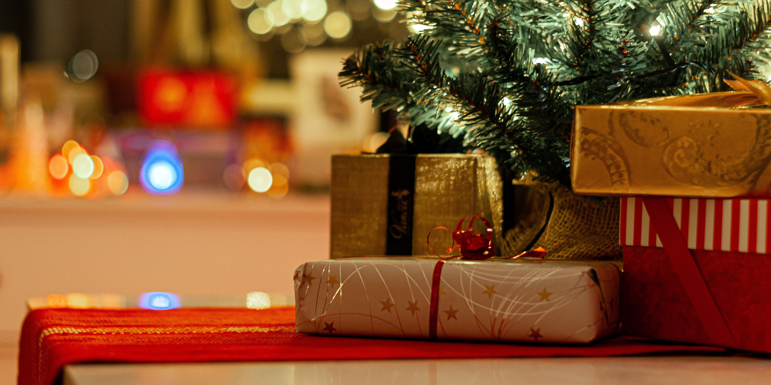 Image of many Christmas presents under tree
