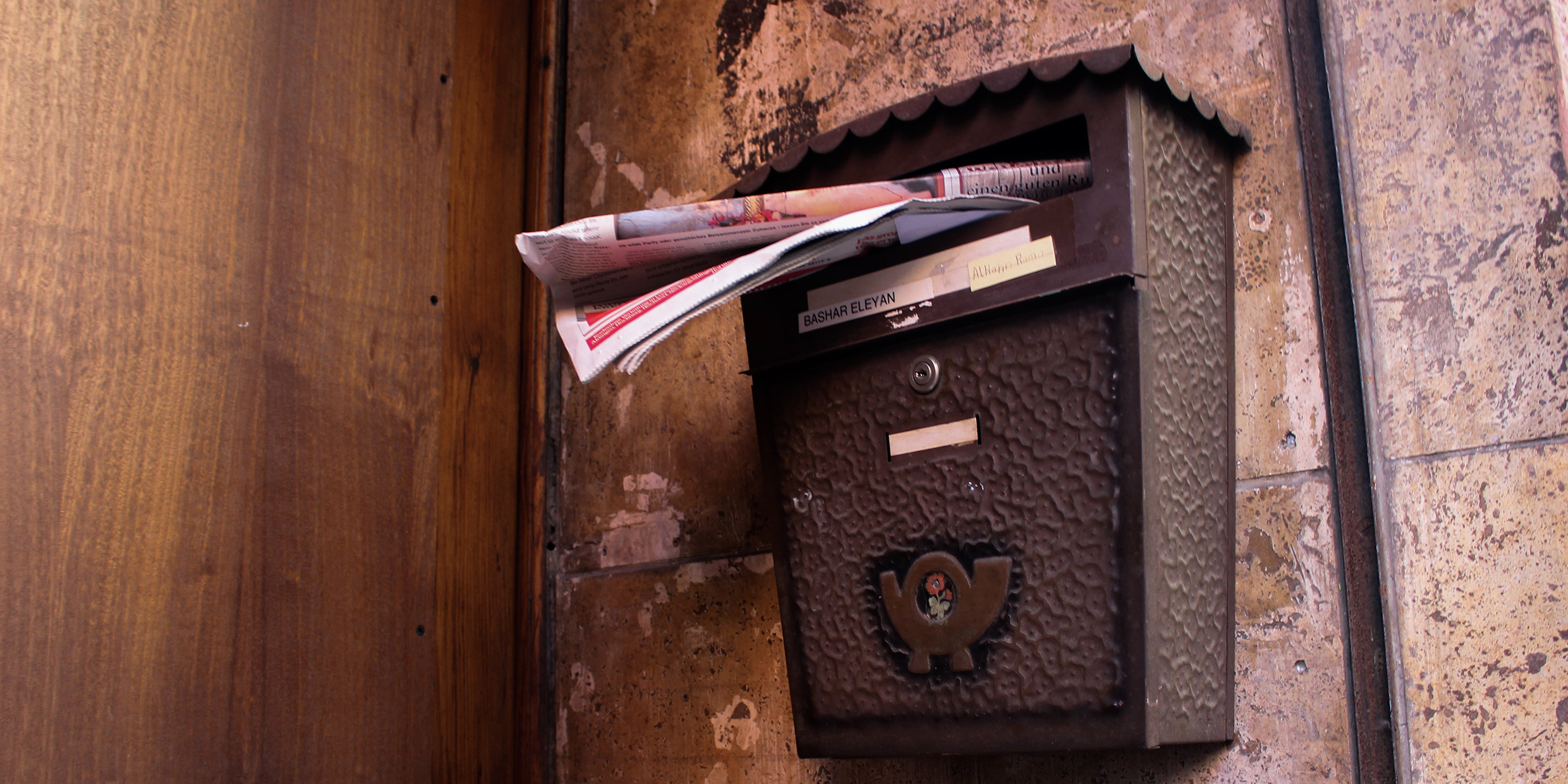 Image of junk mail stuffed into mailbox slot