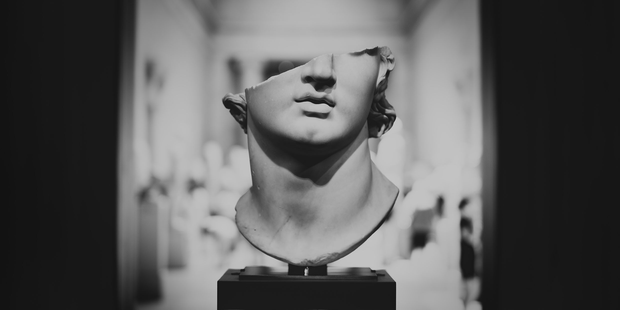 Image of a Greek bust with the top half of the head broken away