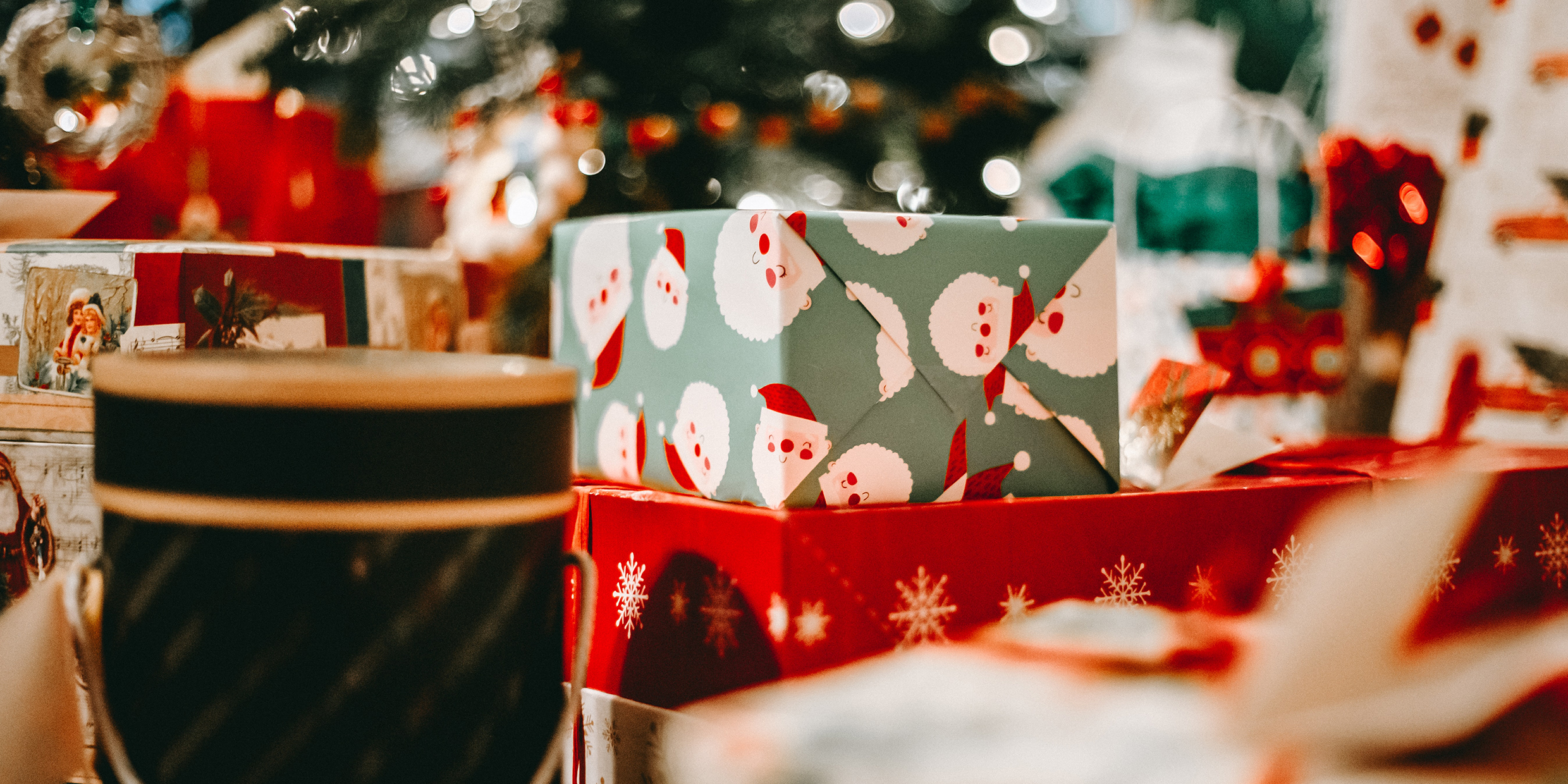 Image of an assortment of wrapped gifts under a Christmas tree