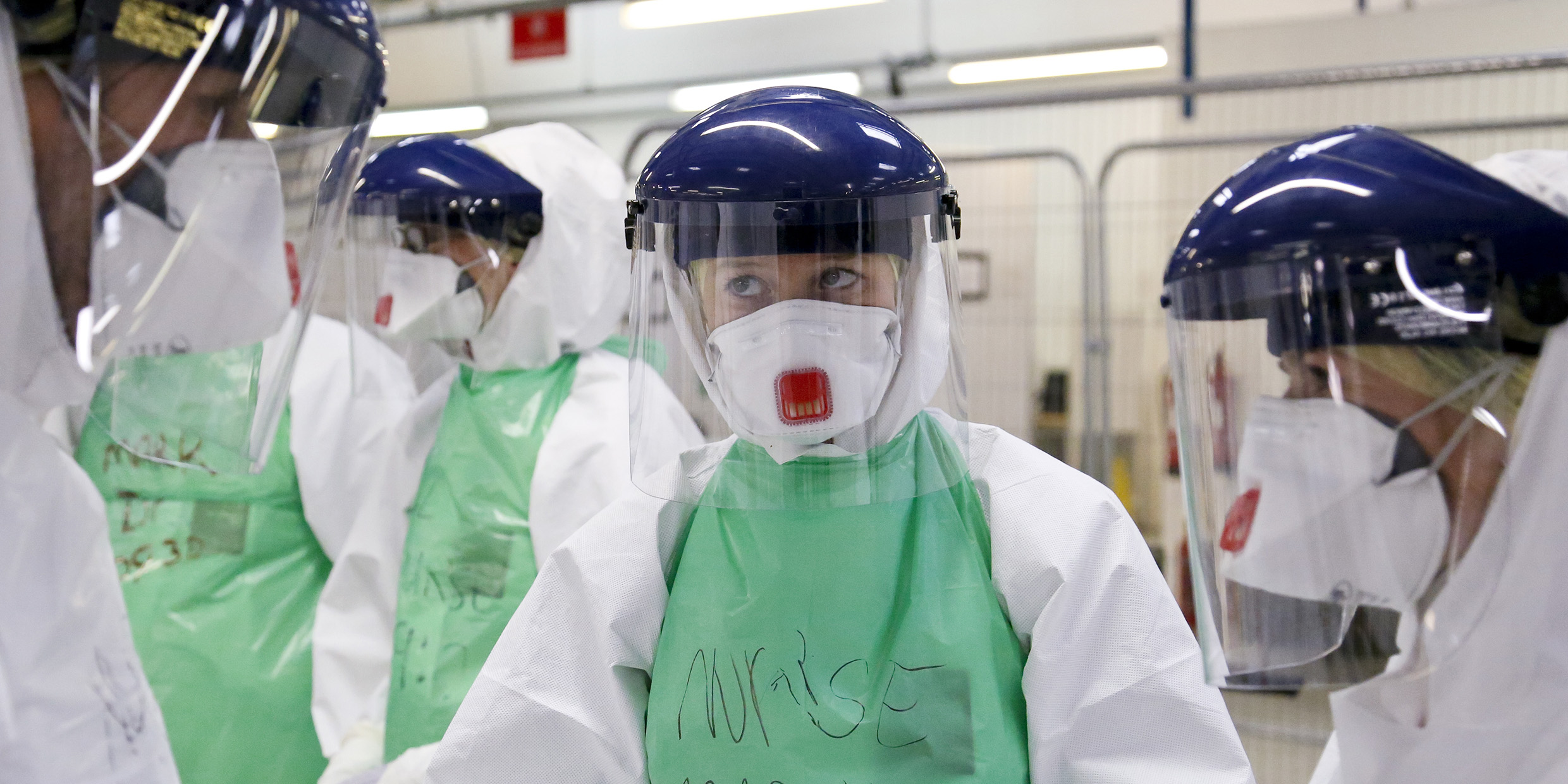 Image of a group of medics clad in extensive protective gear