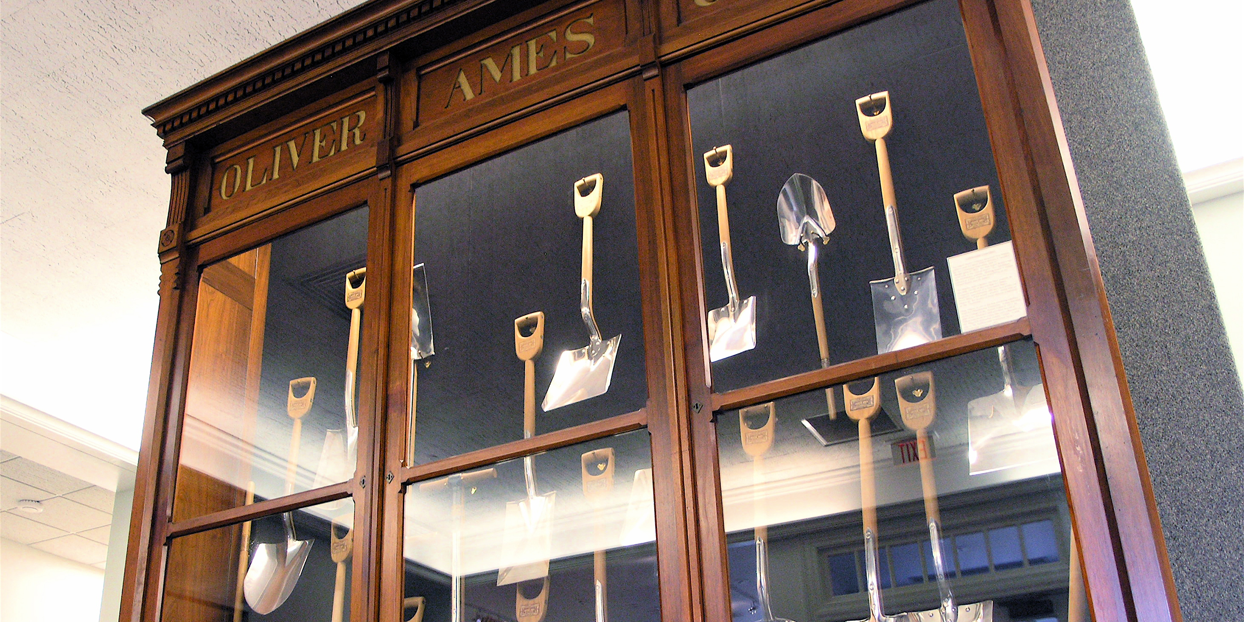 Photo of a collection of shovels inside a display cabinet